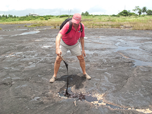 Sampling some of the Tar, Pitch Lake, Trinidad